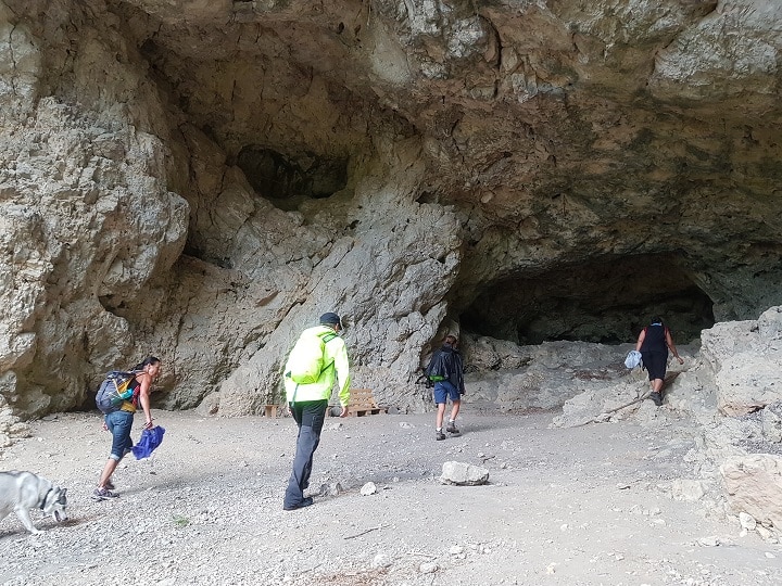Wanderer gehen in Höhle bei Blaubeuren