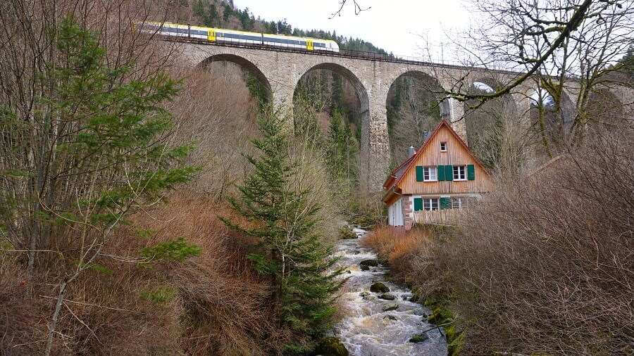 Schönes Haus unterhalb einer Eisenbahnbrücke